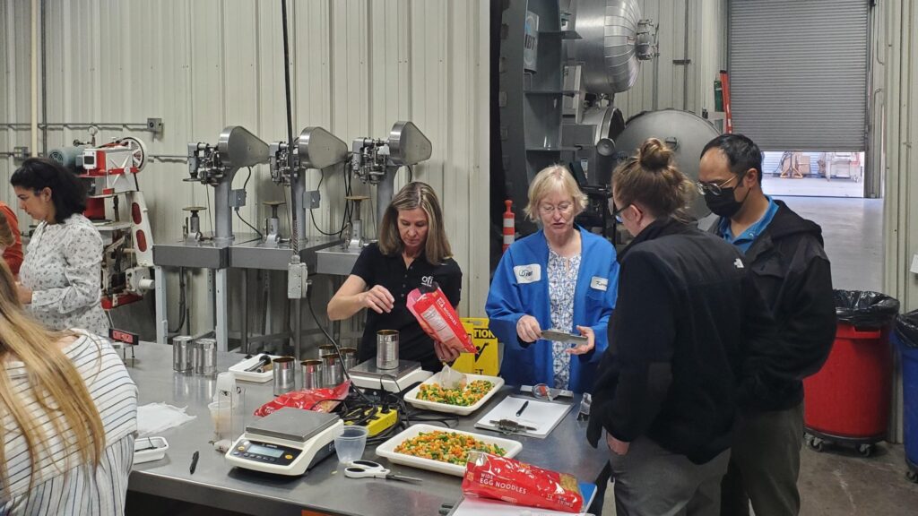 JBT Expert Assurance Researchers in a food lab testing canning recipes at JBT Research and Technology Center