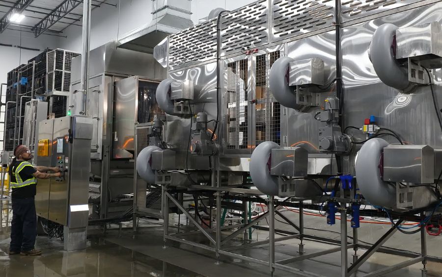 JBTs Bin Drying system with large blowers drying plastic bins after being washed